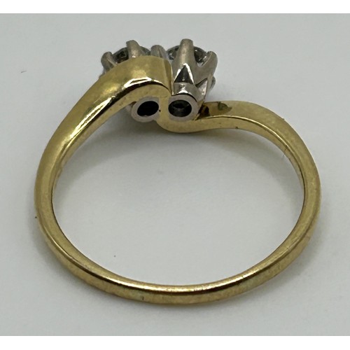 136 - An 18ct gold and diamond crossover ring, ring size M