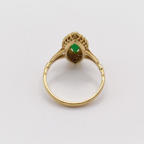 142 - An 18ct gold, diamond and emerald marquise shaped ring, ring size M