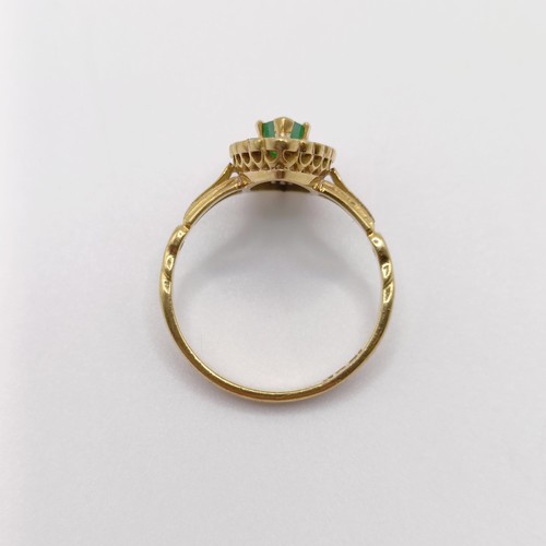 142 - An 18ct gold, diamond and emerald marquise shaped ring, ring size M