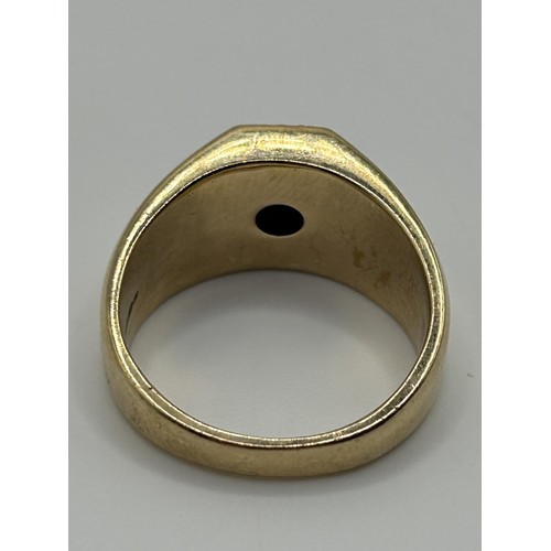 175 - A gentleman's 9ct gold, diamond and black stone signet ring, ring size U