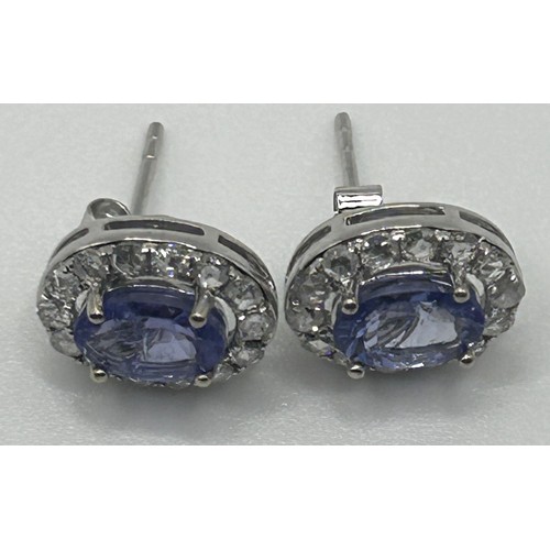 192 - A pair of 18ct white gold, tanzanite and diamond stud earrings