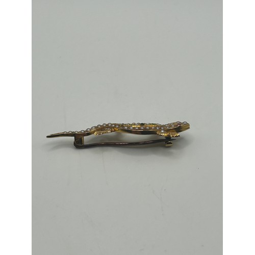 22 - A 9ct gold and multi gemset lizzard bar brooch