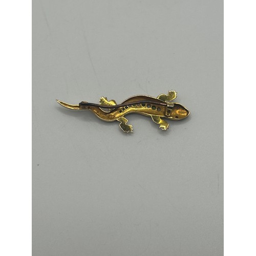 22 - A 9ct gold and multi gemset lizzard bar brooch