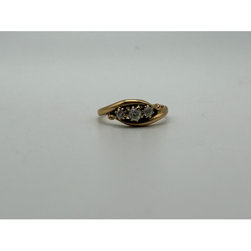 57 - An 18ct gold and three stone diamond ring, ring size M