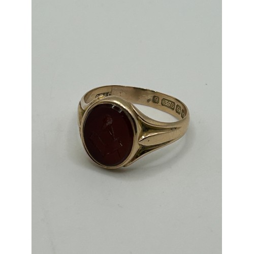 3 - A 9ct gold and carved red stone Masonic signet ring, ring size U, in a modern jewellery box