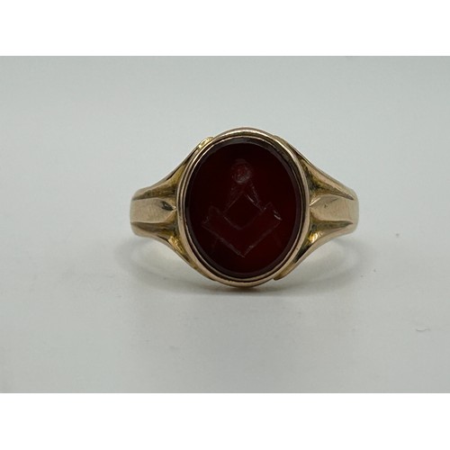 3 - A 9ct gold and carved red stone Masonic signet ring, ring size U, in a modern jewellery box