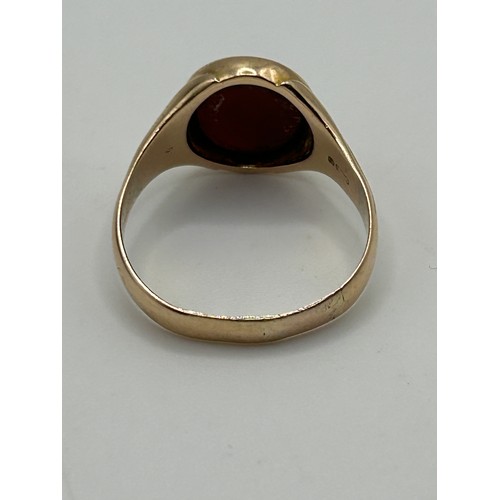 3 - A 9ct gold and carved red stone Masonic signet ring, ring size U, in a modern jewellery box