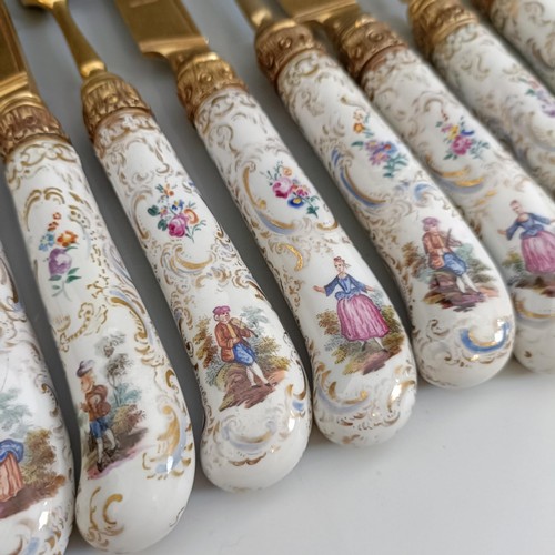 416 - A set of six Continental gilt metal and porcelain pistol handled knives, and a set of six matching f... 