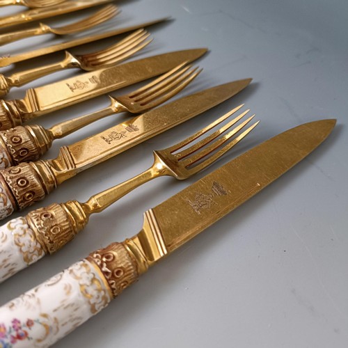 416 - A set of six Continental gilt metal and porcelain pistol handled knives, and a set of six matching f... 