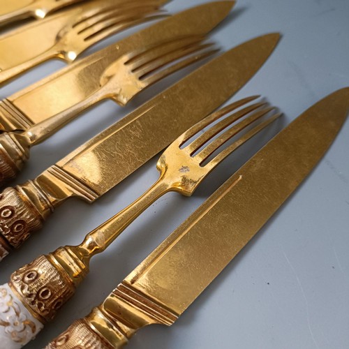 416 - A set of six Continental gilt metal and porcelain pistol handled knives, and a set of six matching f... 