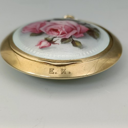 447 - A Continental silver gilt coloured metal and enamel compact, decorated roses, all in 37.1 g