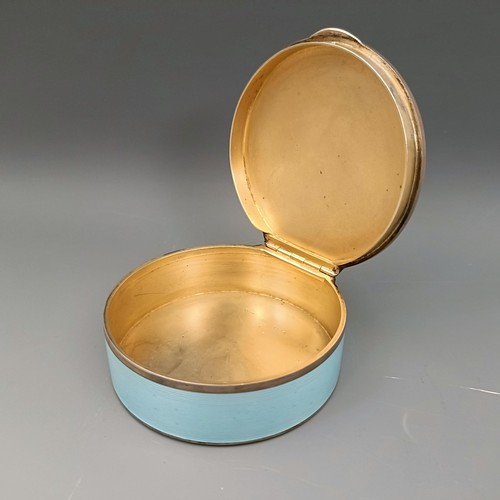 454 - A Continental silver coloured metal and blue enamel circular box, all in 170 g