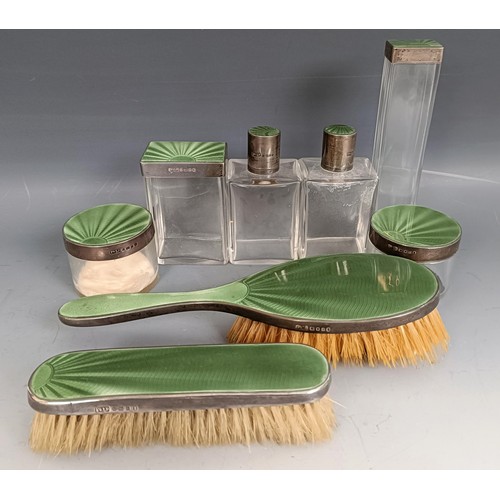 438 - A George V silver and green enamel dressing table set, comprising two glass bottles, with silver mou... 