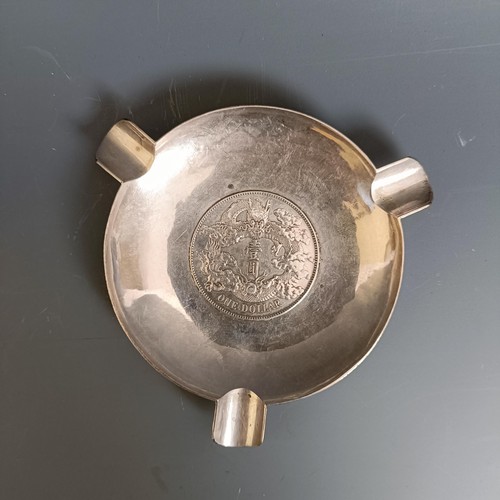 443 - A Chinese silver coloured metal ashtray, inset a coin, 69 g