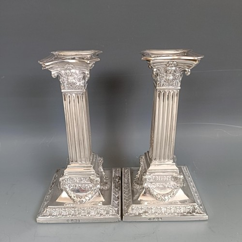 444 - A pair of late Victorian silver candlesticks, in the form of Corinthian columns, Sheffield 1901, bas... 