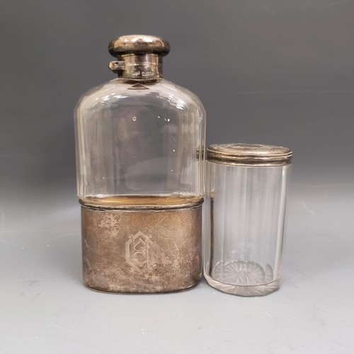 560 - A George V silver and glass hip flask, and a silver topped glass round box (2)