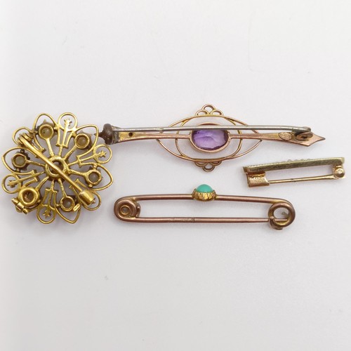 65 - A 9ct gold and purple stone bar brooch, and three other brooches (4)