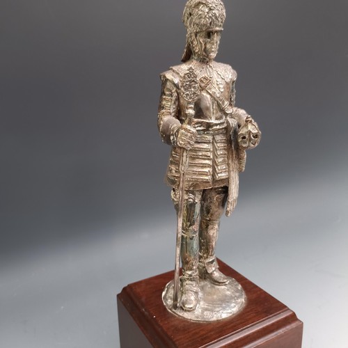 564 - An Elizabeth II silvered figure of a member of the Honourable Artillery Company, on a mahogany base,... 