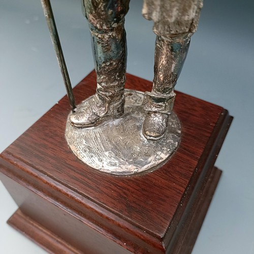 564 - An Elizabeth II silvered figure of a member of the Honourable Artillery Company, on a mahogany base,... 