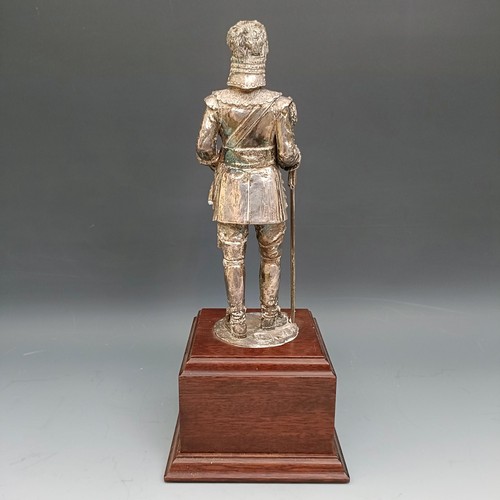 564 - An Elizabeth II silvered figure of a member of the Honourable Artillery Company, on a mahogany base,... 