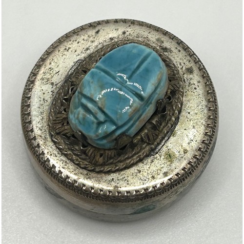 27 - A yellow coloured metal hinged ring, inset with a scarab, the undersigned with hieroglyphics, ring s... 