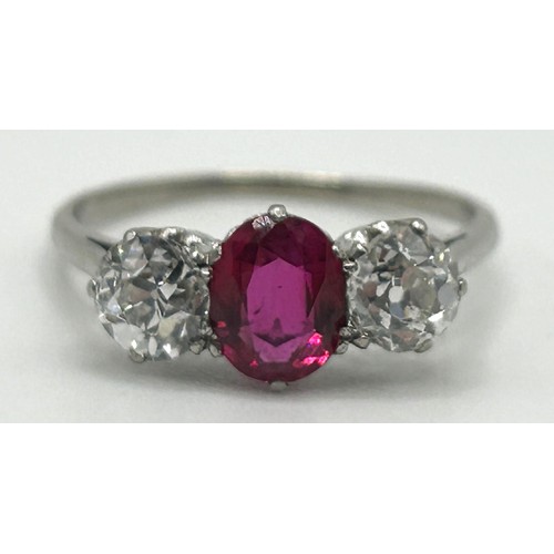 122 - A white coloured metal, ruby and diamond three stone ring, ring size P