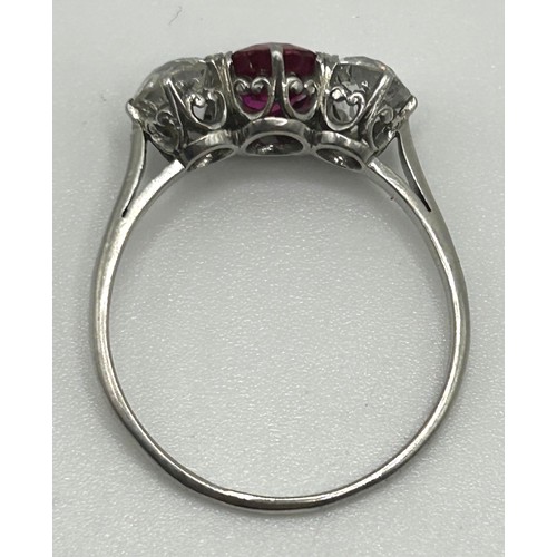 122 - A white coloured metal, ruby and diamond three stone ring, ring size P