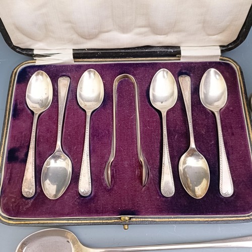 573 - A George V silver egg cup, a set of six teaspoons, with matching sugar tongs, cased, and a spoon, 6 ... 