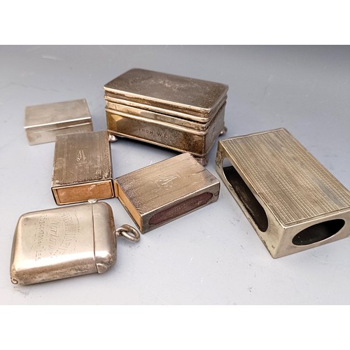 577 - A George V silver ring box, Birmingham 1914, a pill box, three matchbox holders, and a vesta