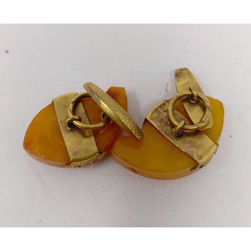 12 - A pair of novelty amber and gilt metal cufflinks, in the form of fish