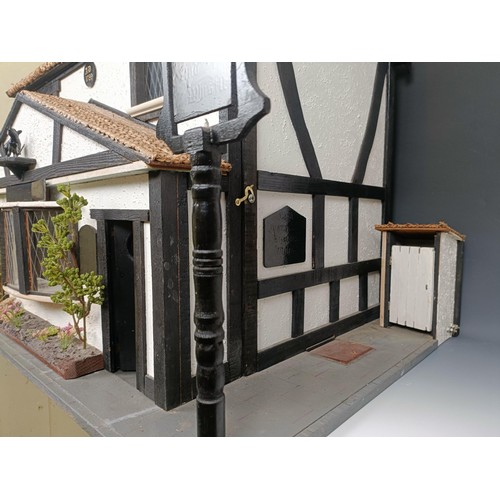 851 - An unusual doll's house, in the form of the pub called The Pig and Whistle, in the Tudor style, with... 