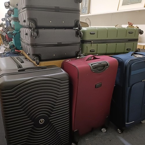 701 - A large group of assorted suitcases, various sizes, as removed from The Wincanton Cobblers