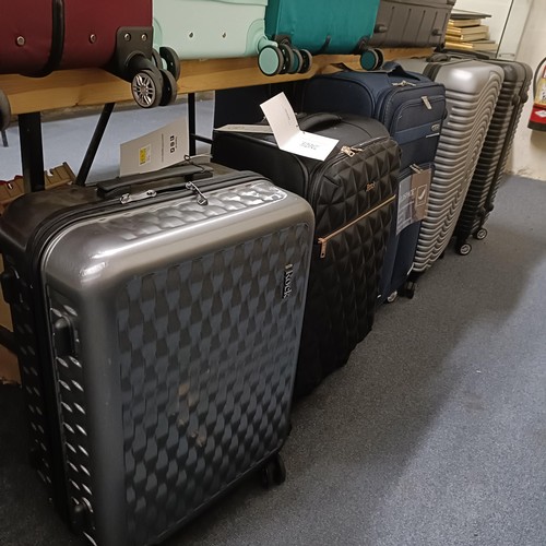 701 - A large group of assorted suitcases, various sizes, as removed from The Wincanton Cobblers