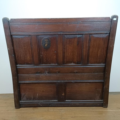 874 - A 17th century style carved oak settle, with a painted leather panel to the seat and arms, 130 cm wi... 