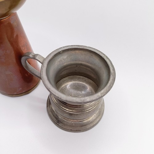 819 - A pewter drinking vessel, with a brass and copper jug (2)