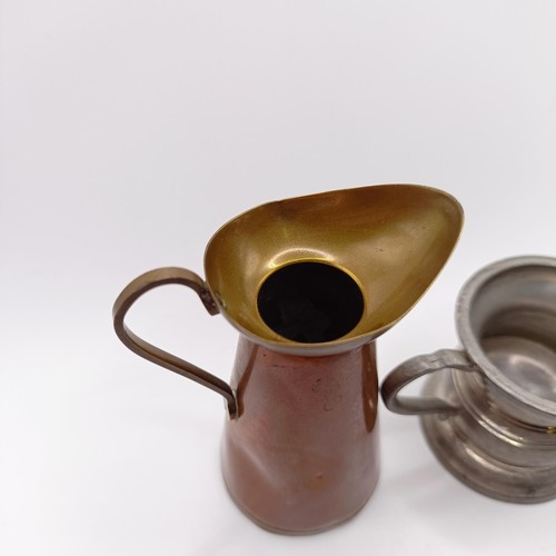 819 - A pewter drinking vessel, with a brass and copper jug (2)