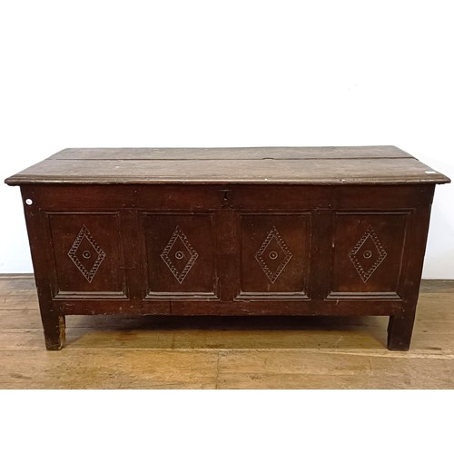 888 - An 18th century oak coffer, carved lozenges, on stile legs, 140 cm wide