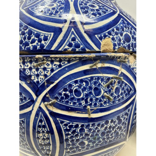 706 - A pair of Moorish pottery style vases and covers, with blue glazed decoration, 35 cm high