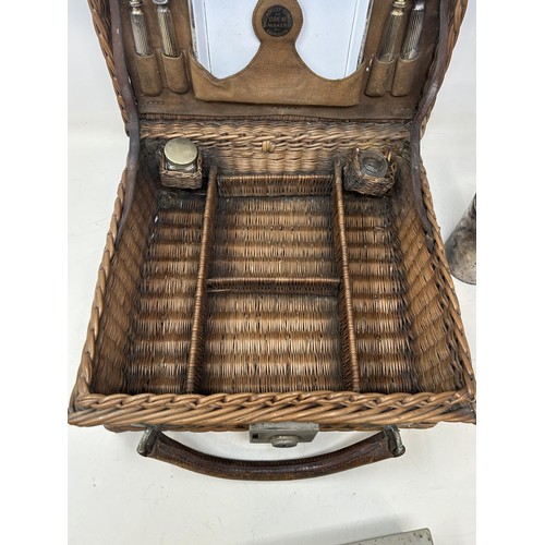 763 - A late 19th/early 20th century whicker picnic basket, contents to include two plates, two forks, a k... 