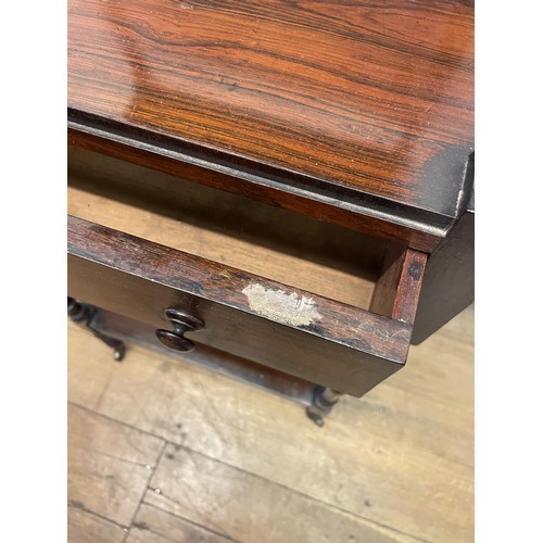 891 - A 19th century rosewood whatnot, with a central drawer, raised on castors, 133 x 56 cm