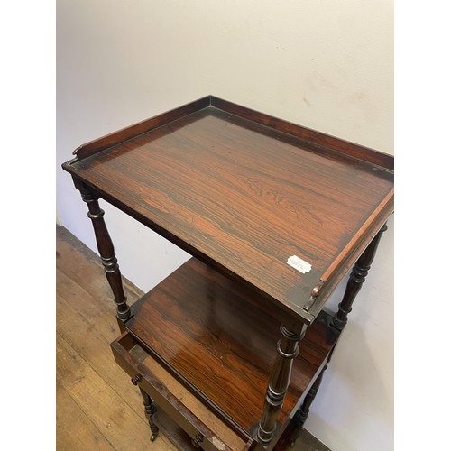 891 - A 19th century rosewood whatnot, with a central drawer, raised on castors, 133 x 56 cm