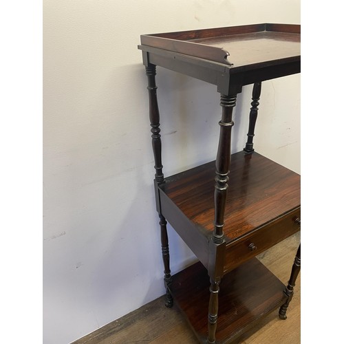 891 - A 19th century rosewood whatnot, with a central drawer, raised on castors, 133 x 56 cm