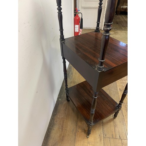 891 - A 19th century rosewood whatnot, with a central drawer, raised on castors, 133 x 56 cm