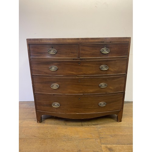 883 - A 19th century bow front mahogany chest, having two short and three long drawers, 103 cm wide