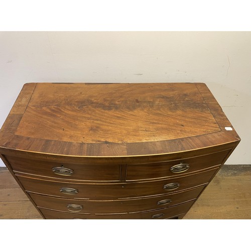 883 - A 19th century bow front mahogany chest, having two short and three long drawers, 103 cm wide