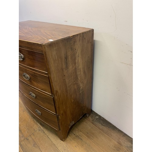 883 - A 19th century bow front mahogany chest, having two short and three long drawers, 103 cm wide