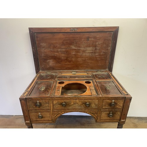 876 - A 19th century mahogany enclosed dressing table, the hinged top to reveal a fitted interior, to incl... 