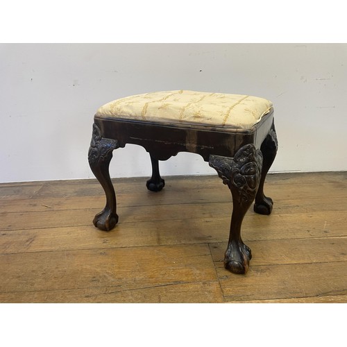 886 - A George III style footstool, raised on carved cabriole legs to ball and claw feet, 53 cm wide