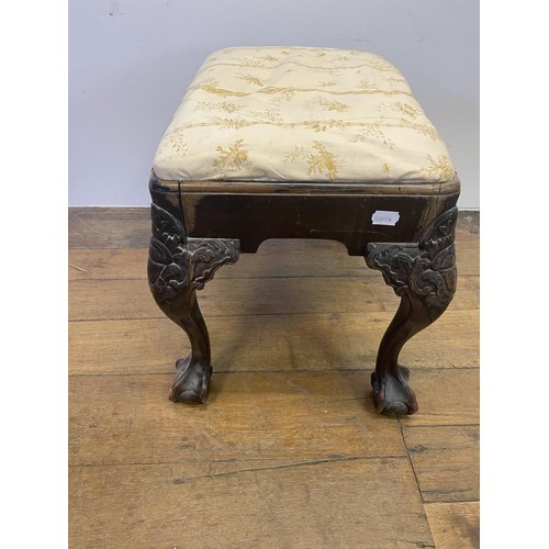 886 - A George III style footstool, raised on carved cabriole legs to ball and claw feet, 53 cm wide