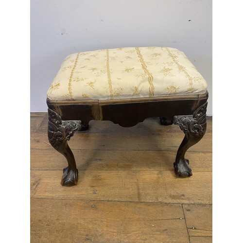 886 - A George III style footstool, raised on carved cabriole legs to ball and claw feet, 53 cm wide